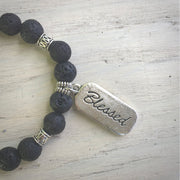 close-up of the front of the blessed charm and lava stone beads