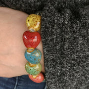  Close-up of the Colorful 'His Steadfast Love' Ceramic Heart bead Bracelet worn on Model's wrist
