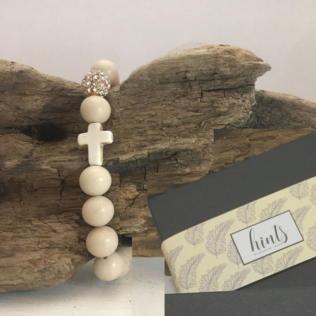 Close-up the ‘Thou Art With Me’ White Fossil Natural Stone  with Ivory Cross Bead  Bracelet over drift wood