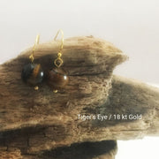 close-up of the Natural Stone Blessing Earrings—Tiger’s Eye bead and Sterling Silver Hook plated in 18k gold
