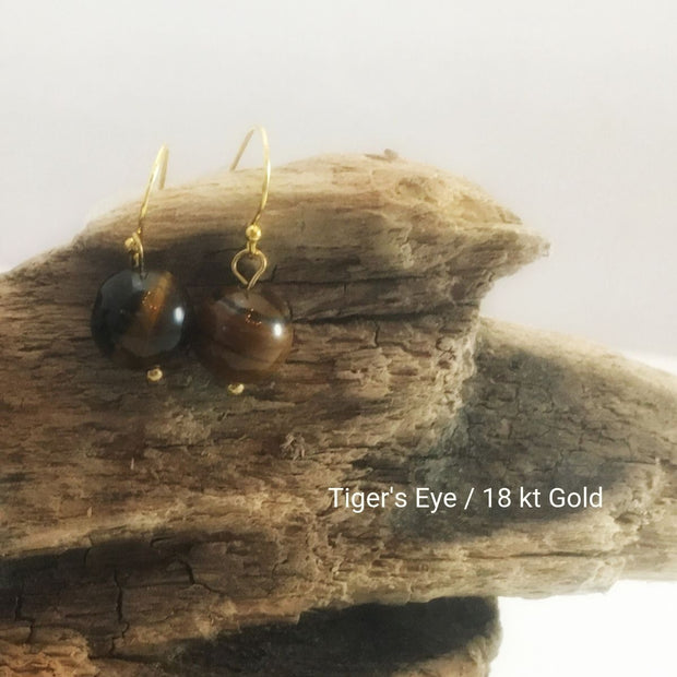 close-up of the Natural Stone Blessing Earrings—Tiger’s Eye bead and Sterling Silver Hook plated in 18k gold