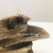 close-up of the  Natural Stone Blessing Earrings—Lava Stone bead and Sterling Silver Hook plated in 18k gold